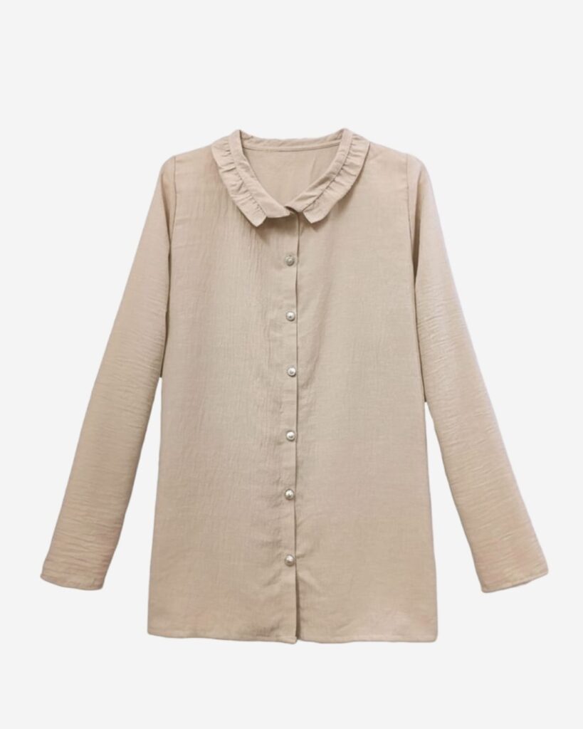 Beige linen blouse laid flat showing front silver buttons, delicate ruffled collar, and long sleeves with a classic modest design by Asmaa Basha.