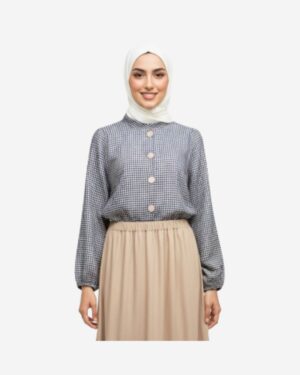 Model wearing a beige checkered linen blouse with wide sleeves and elastic cuffs, styled in a modest casual outfit by Asmaa Basha.